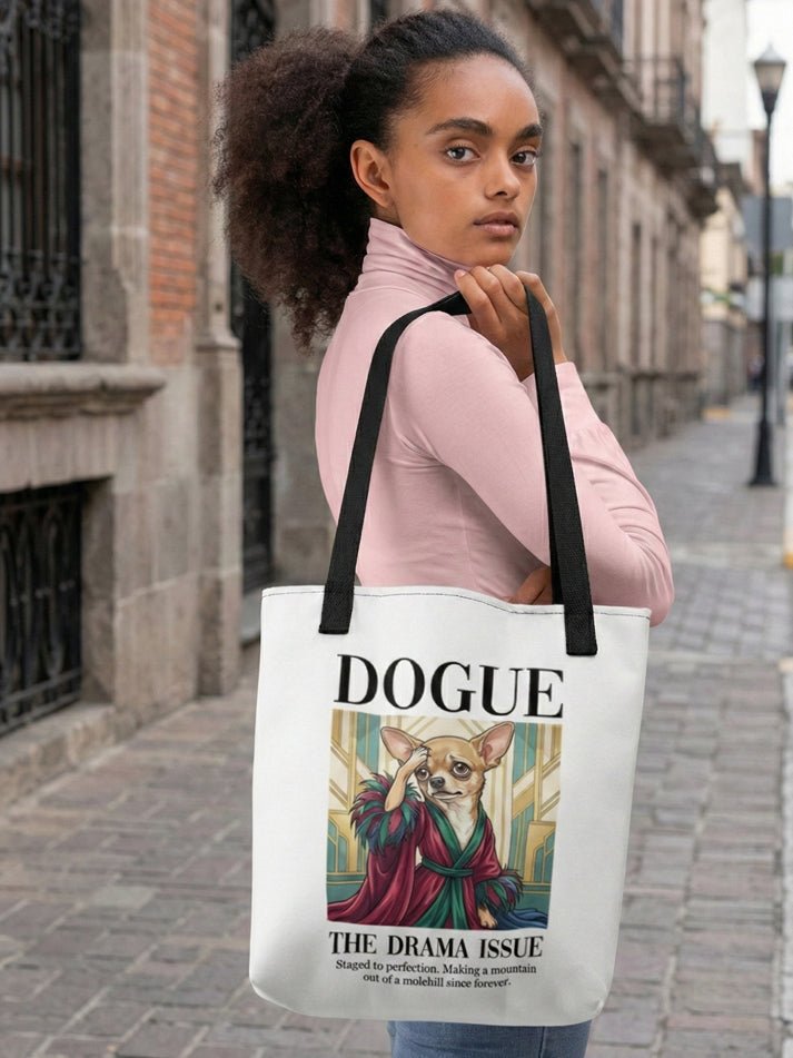 Person holding a tote bag with a dog-themed design on a city street.